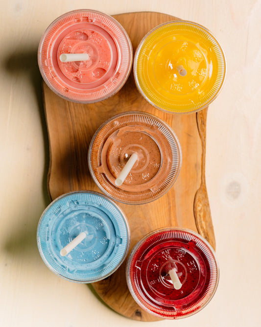Five colorful smoothies from Golden Juicery laid out for breakfast in Jupiter FL
