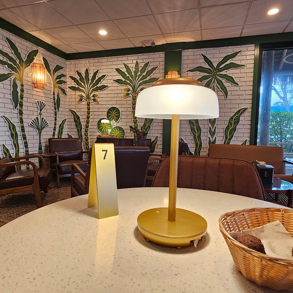 Golden Juicery Tequesta interior with palm tree wallpaper