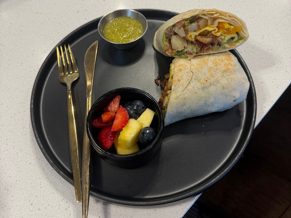 Breakfast wrap with fresh fruit cup and salsa at Golden Juicery Tequesta